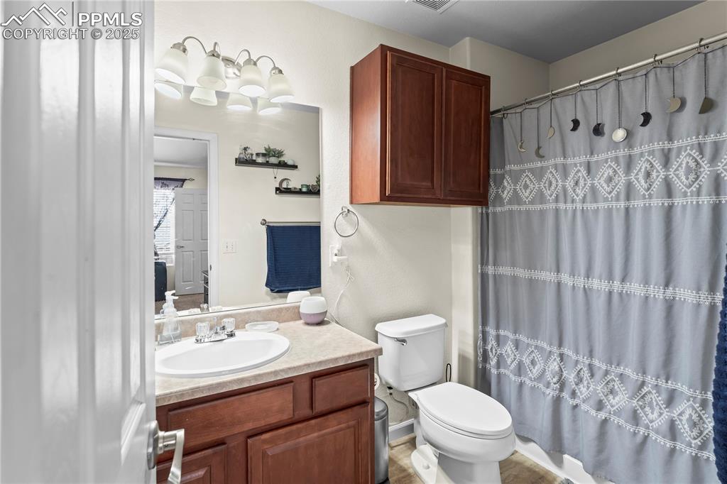 Image 23 of 25: Full bathroom with vanity and curtained shower