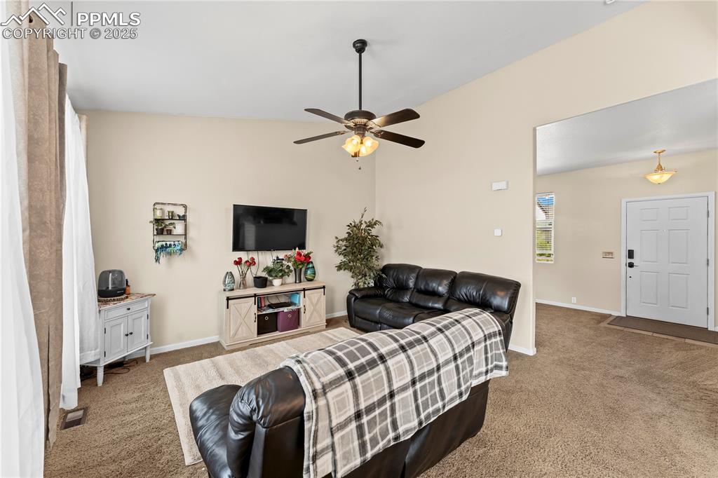 Image 9 of 25: Living area featuring carpet floors and ceiling fan