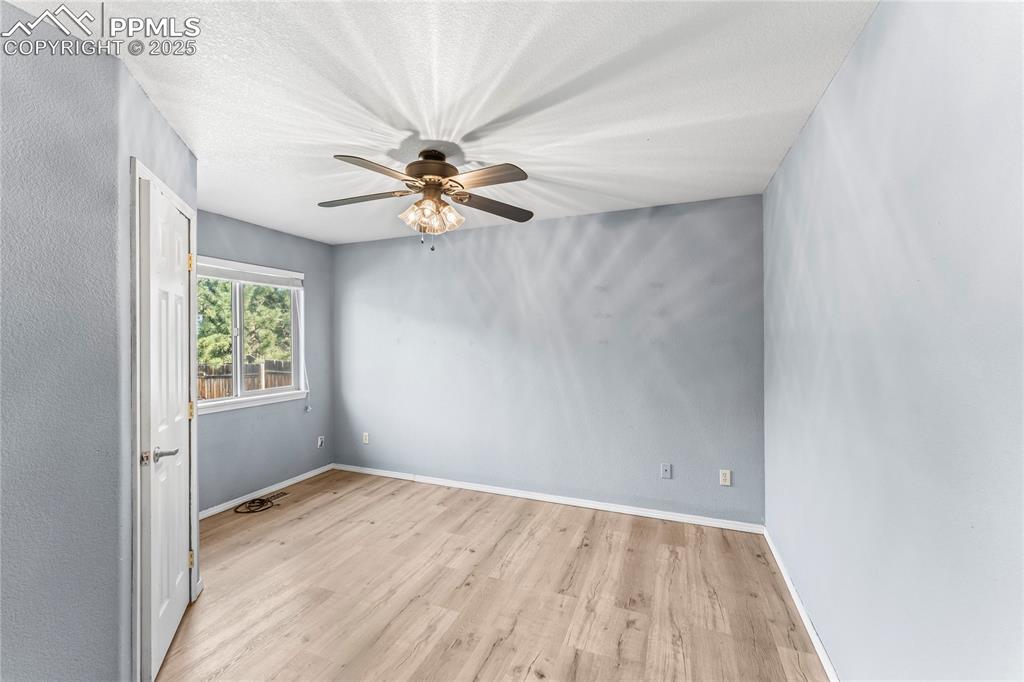Image 15 of 37: Spare room featuring wood finished floors and a ceiling fan