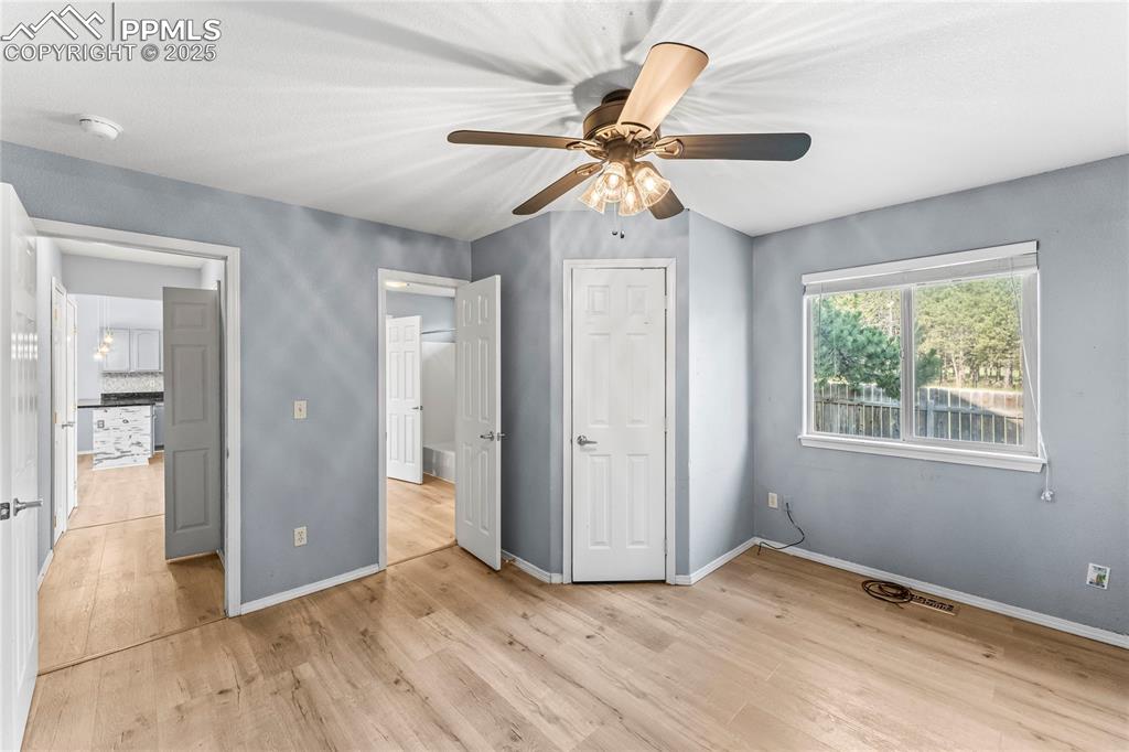 Image 16 of 37: Unfurnished bedroom with light wood finished floors, a ceiling fan, and lof