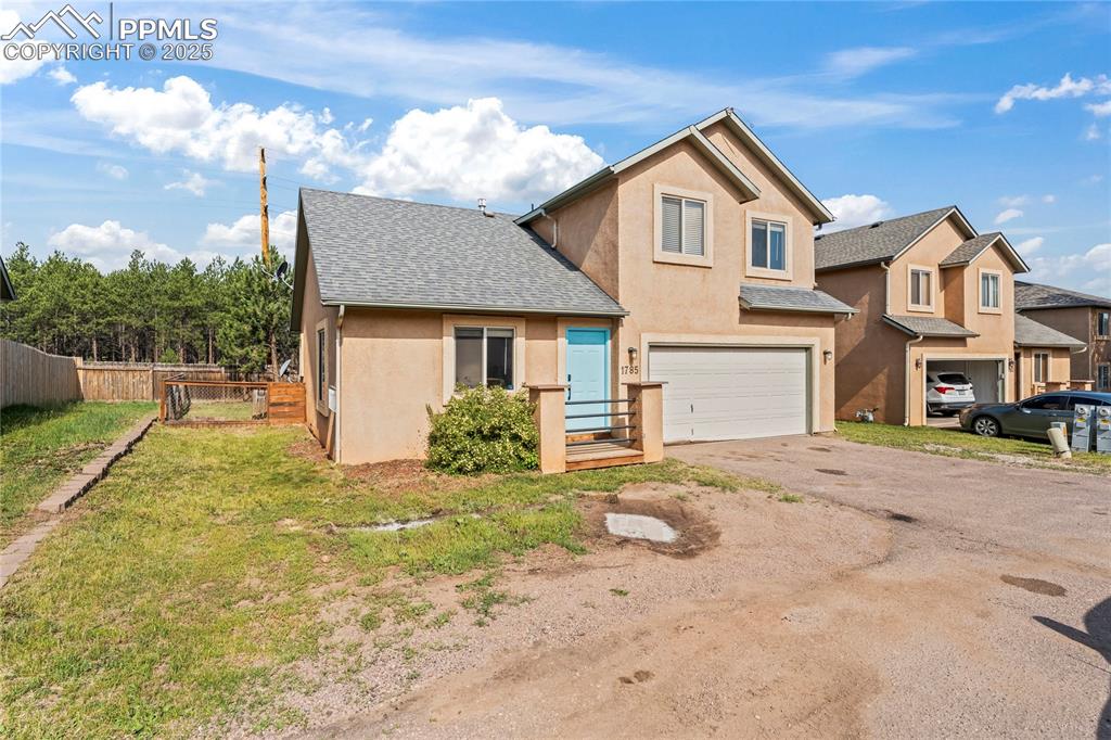 Image 2 of 37: Traditional-style home featuring driveway, stucco siding, roof with shingle