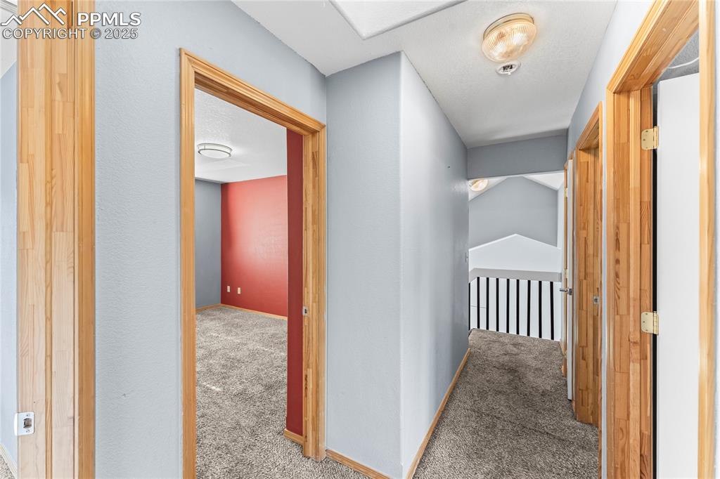 Image 20 of 37: Upstairs Hallway with carpet flooring and an upstairs landing