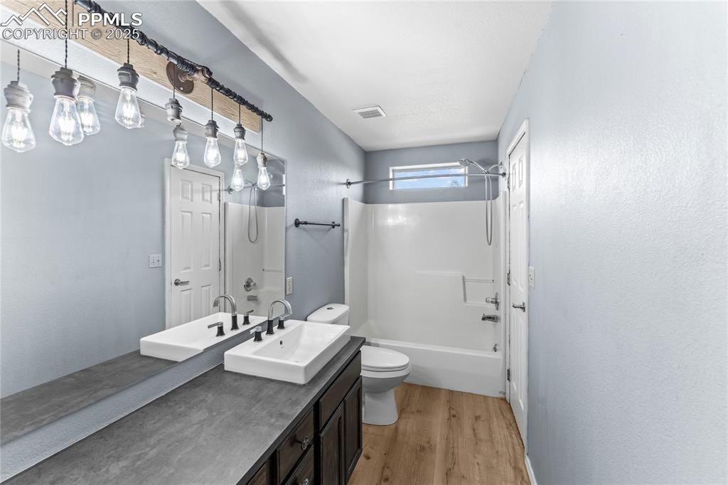 Image 21 of 37: 2nd Floor Bathroom featuring wood finished floors, shower combination, and