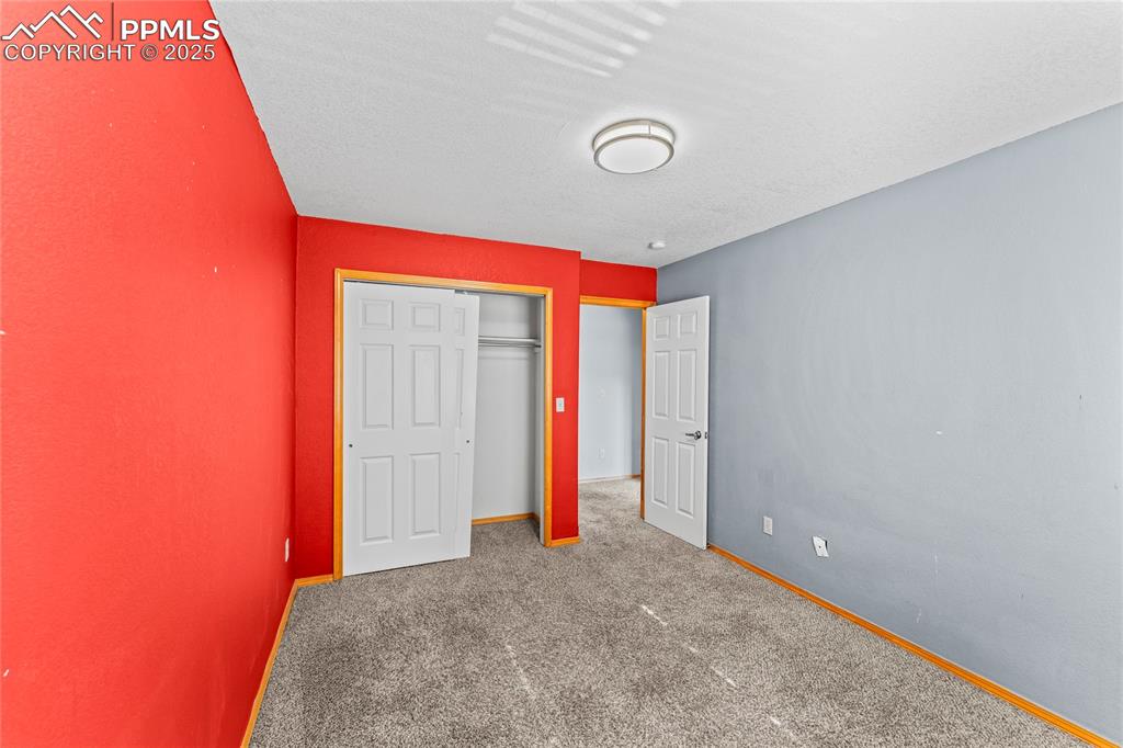 Image 24 of 37: 2nd Floor Unfurnished bedroom with a closet, carpet, and a textured ceiling