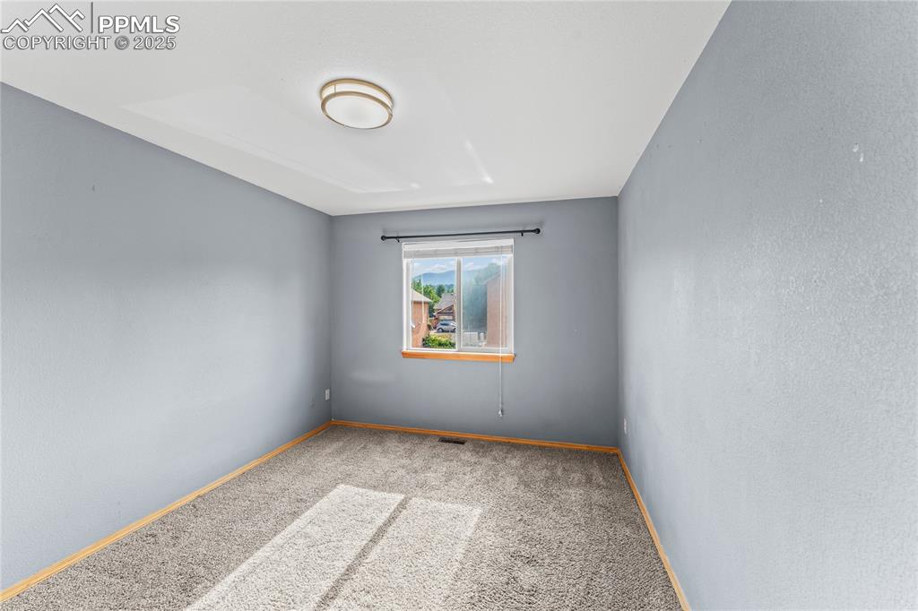 Image 26 of 37: 2nd Floor Bedroom Carpeted empty room with baseboards