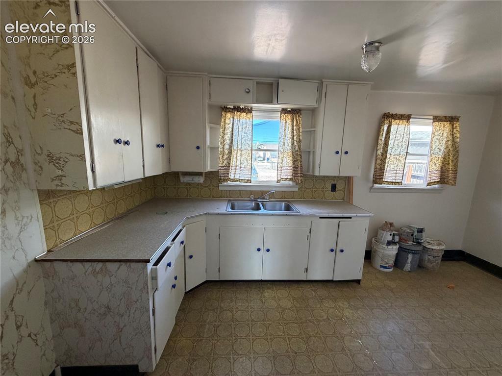 Image 19 of 28: ADU- Kitchen  featuring white cabinetry, dual-basin stainless steel sink, p