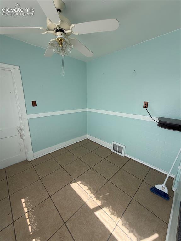 Image 4 of 28: Ceiling fan with light fixture, tiled flooring, and accent wall molding