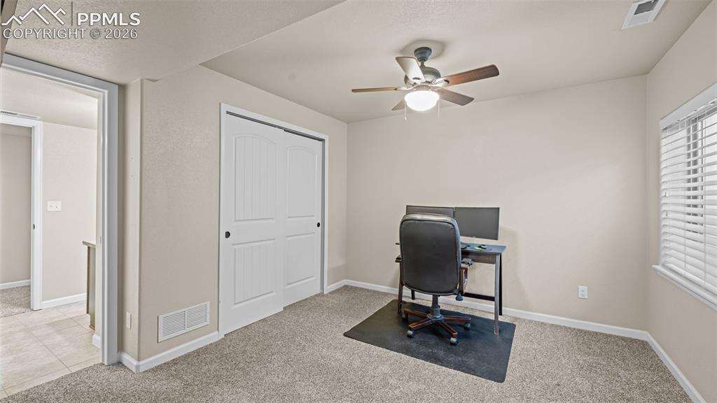 Image 19 of 27: first bedroom in basement featuring a ceiling fan with integrated lighting,