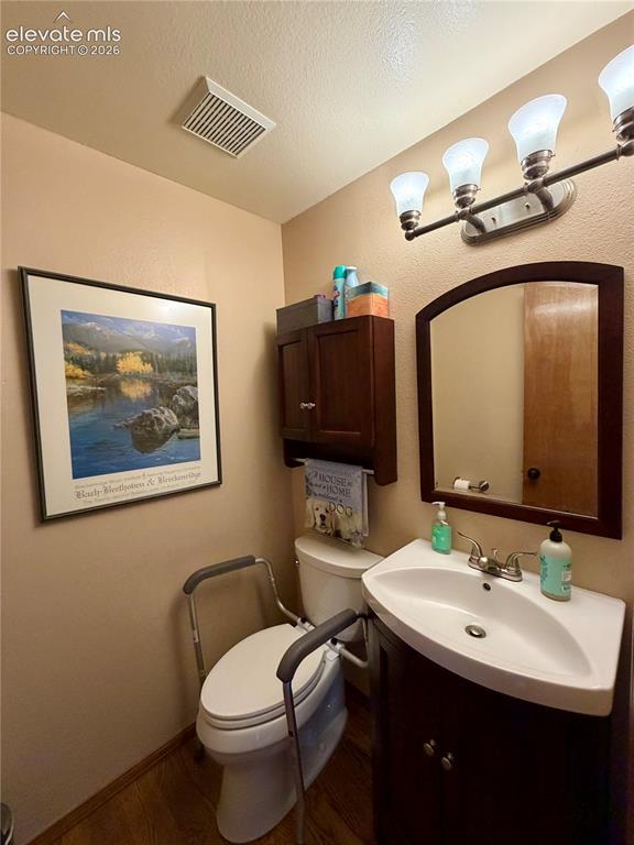Image 19 of 49: Main Floor Guest Bathroom featuring wood-finish flooring and neutral wall t