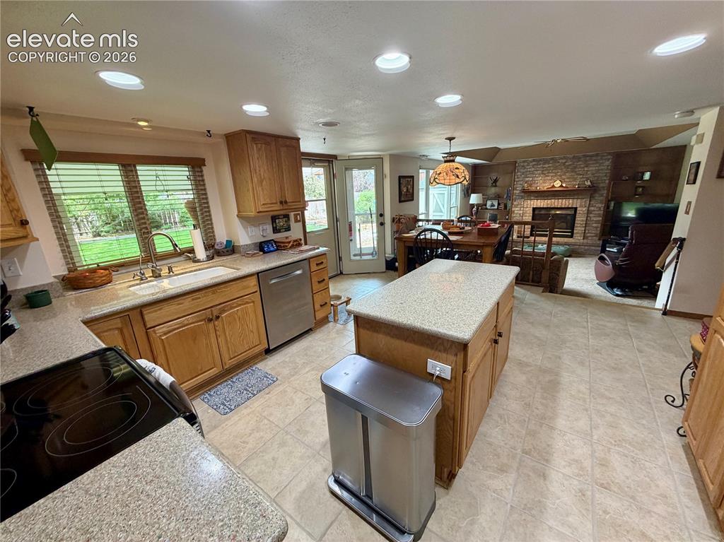 Image 20 of 49: Kitchen featuring wood cabinetry, light-toned countertops, and stainless st