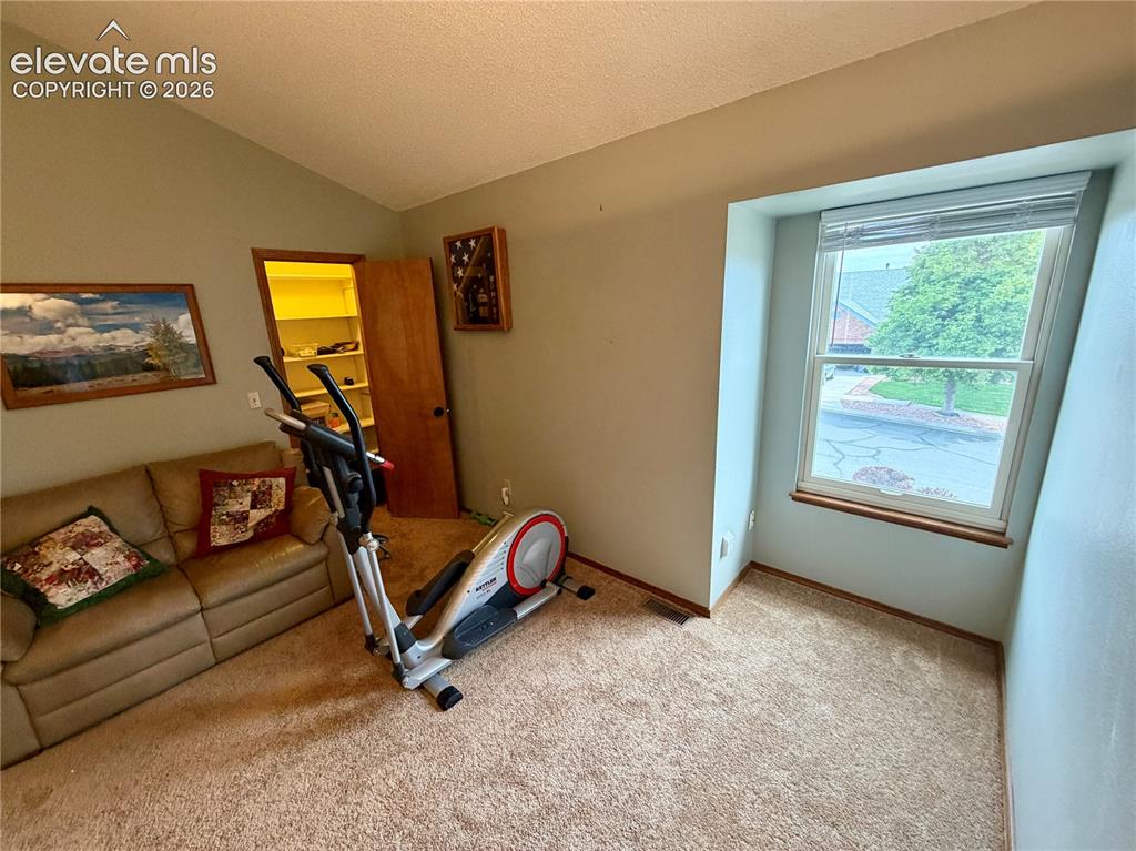 Image 35 of 49: Carpeted room featuring a single window with blinds, a built-in closet with