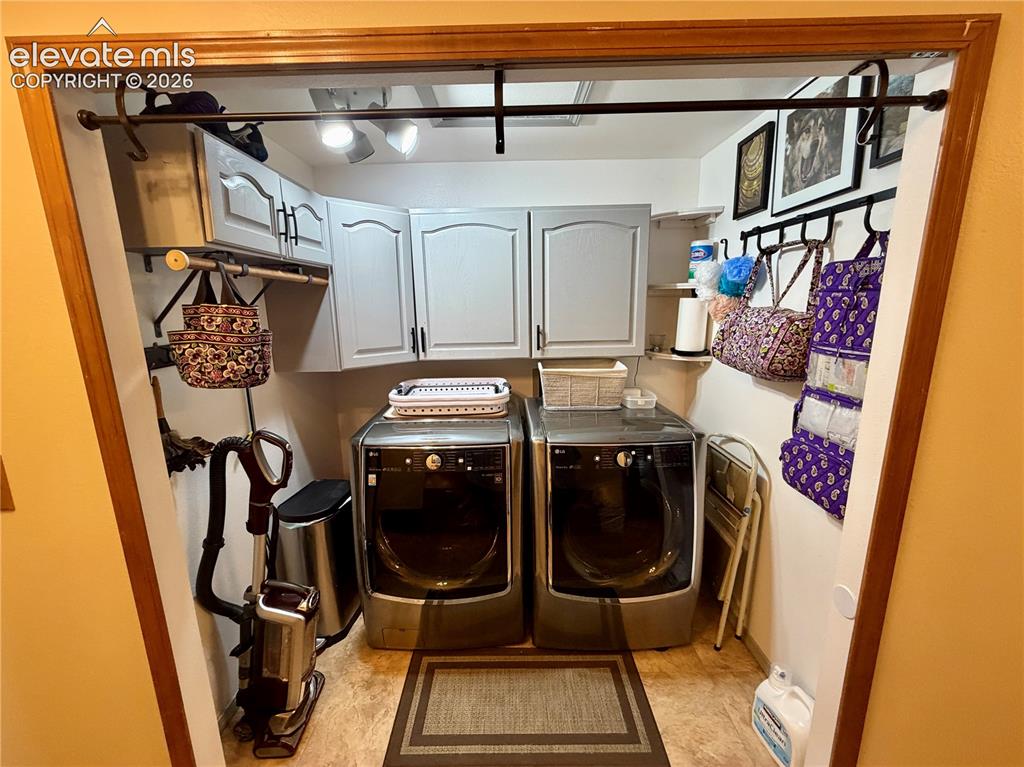 Image 36 of 49: Dedicated utility area featuring overhead cabinetry, wall-mounted storage s