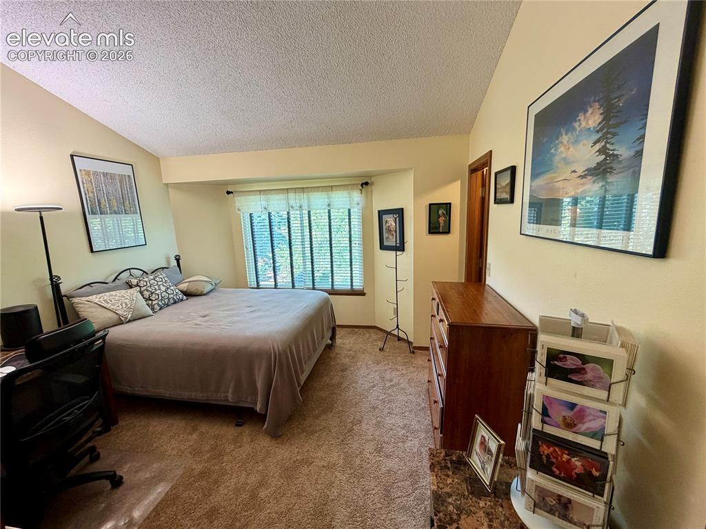 Image 40 of 49: Bedroom featuring light beige walls and brown carpet flooring