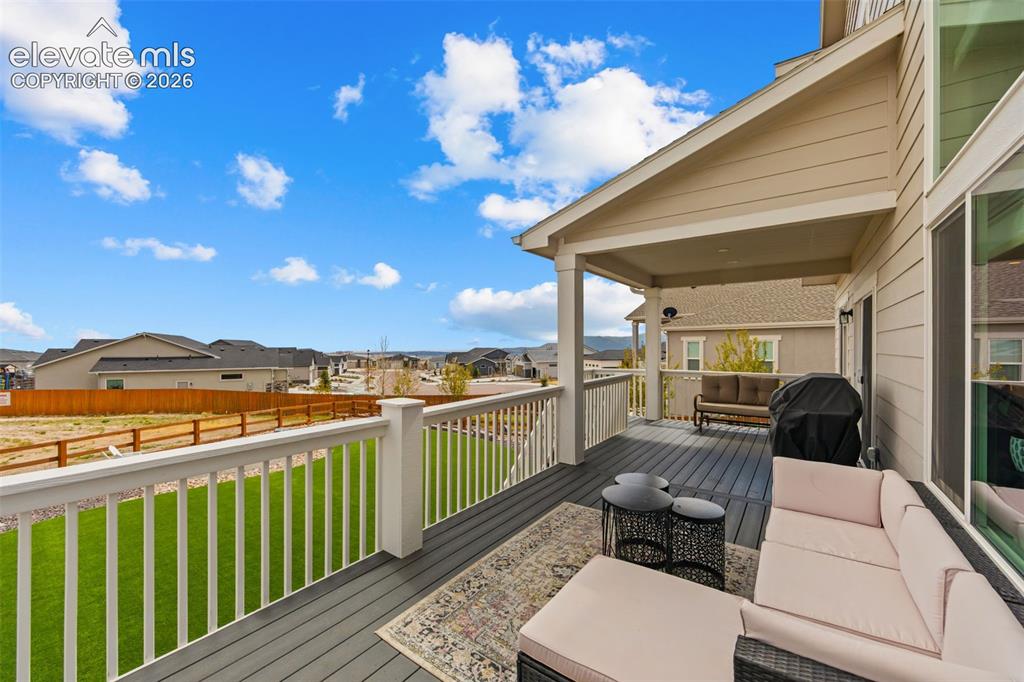 Image 33 of 46: Huge deck overlooks the expansive yard