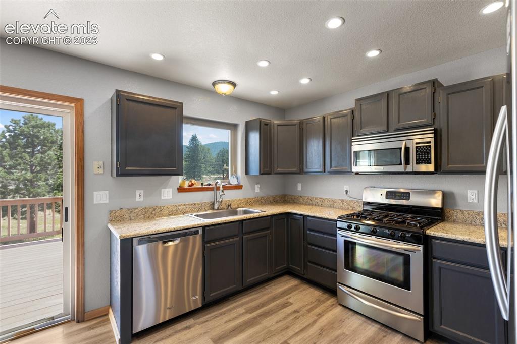 Image 10 of 36: Kitchen with walk out. 