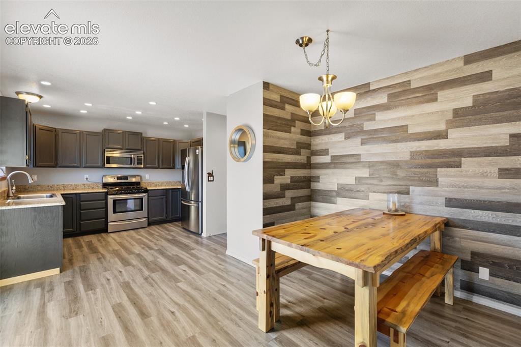 Image 12 of 36: Kitchen and dining area with walk out. 