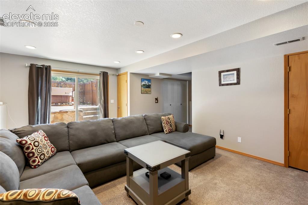 Image 22 of 36: Walk out basement to hot tub and family room.