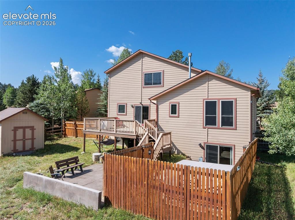 Image 27 of 36: Back pf property with hot tub and privacy fence! 