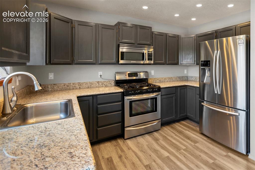 Image 9 of 36: Kitchen with walk out.