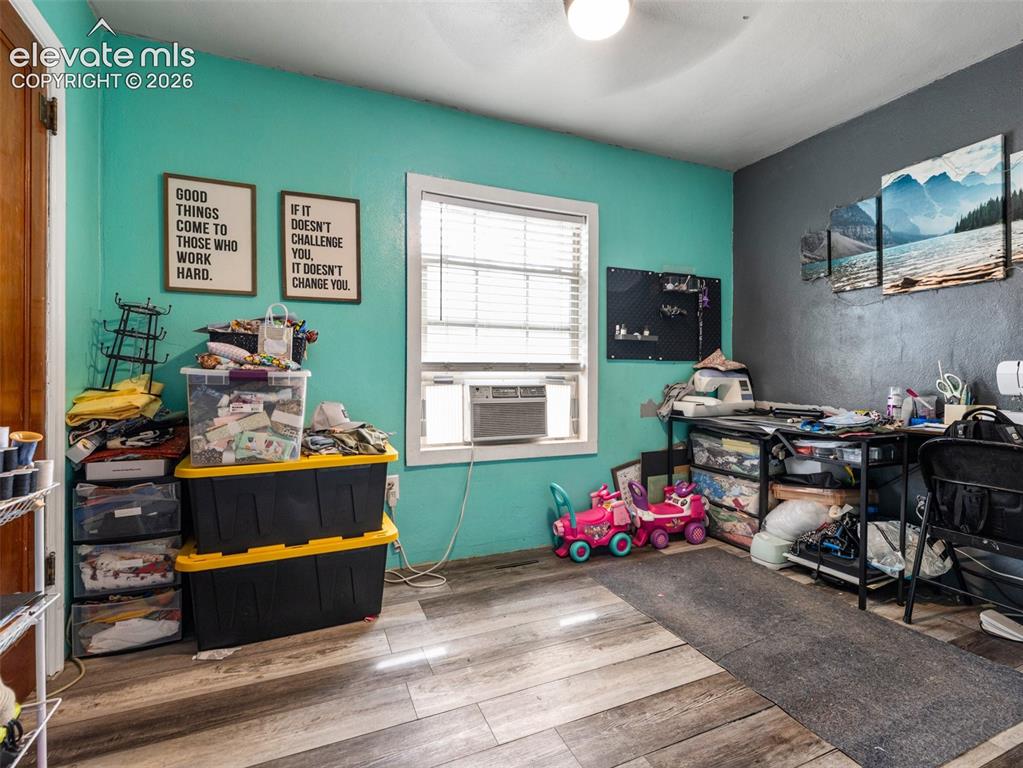 Image 11 of 26: Wood-finish flooring with a window featuring blinds
