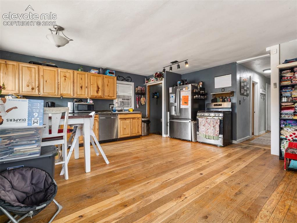 Image 3 of 26: Wood-finish flooring throughout, natural wood cabinetry, stainless steel ap