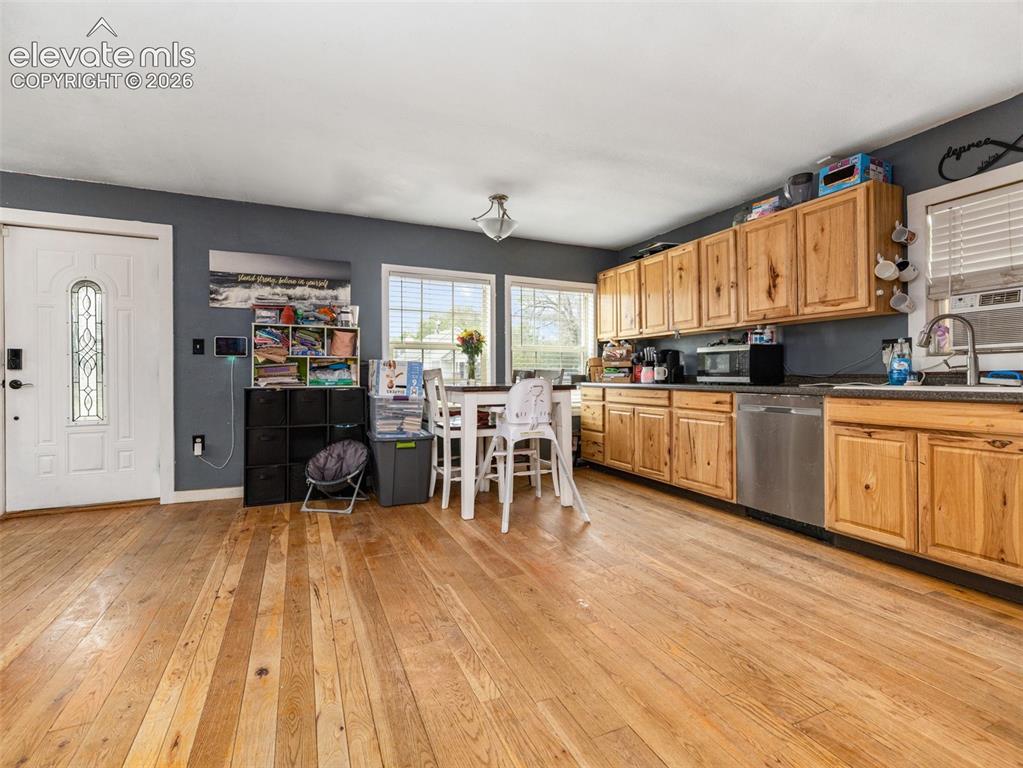 Image 4 of 26: Spacious kitchen featuring wood cabinetry, stainless steel appliances, and