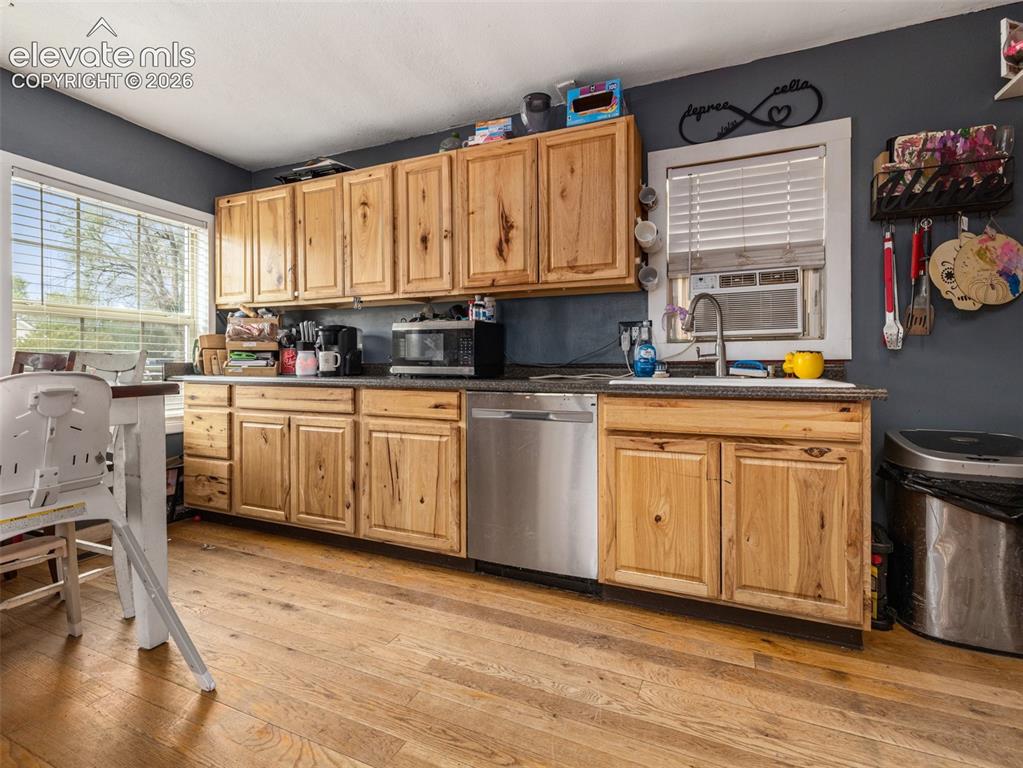 Image 9 of 26: Spacious kitchen featuring warm wood-finish cabinetry with ample storage, s