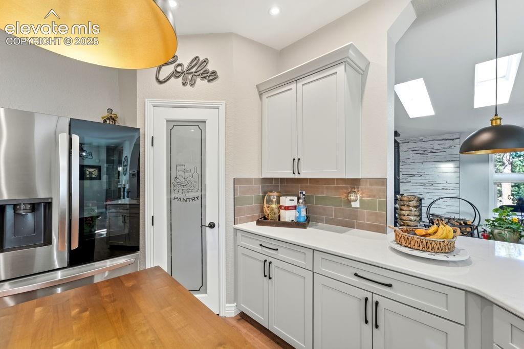 Image 27 of 50: Stainless steel refrigerator, pantry door with frosted glass, light cabinet