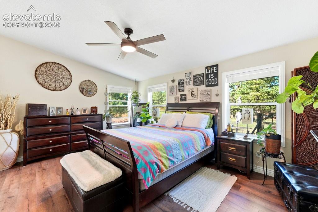 Image 34 of 50: Vaulted ceiling with a contemporary ceiling fan, wood-finish flooring, and 