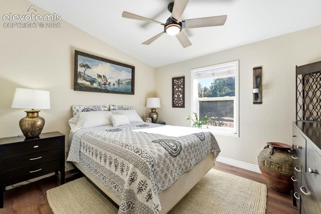 Image 42 of 50: Wood-finish flooring, ceiling fan with integrated lighting, and a window wi