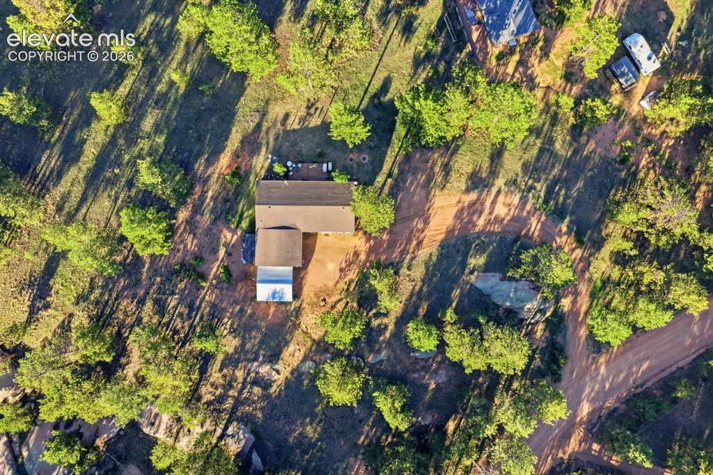 Image 46 of 50: Property with a main residence, an auxiliary structure, and surrounding mat