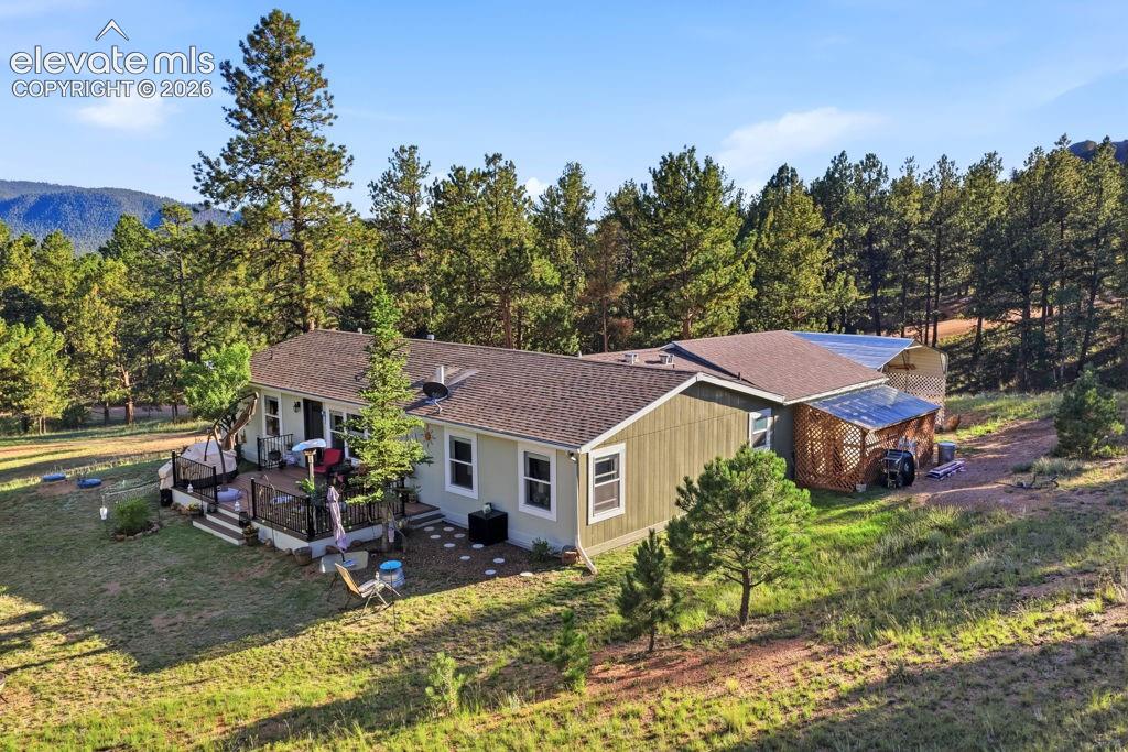 Image 9 of 50: Single-story residence featuring a composite roof, light green siding, and