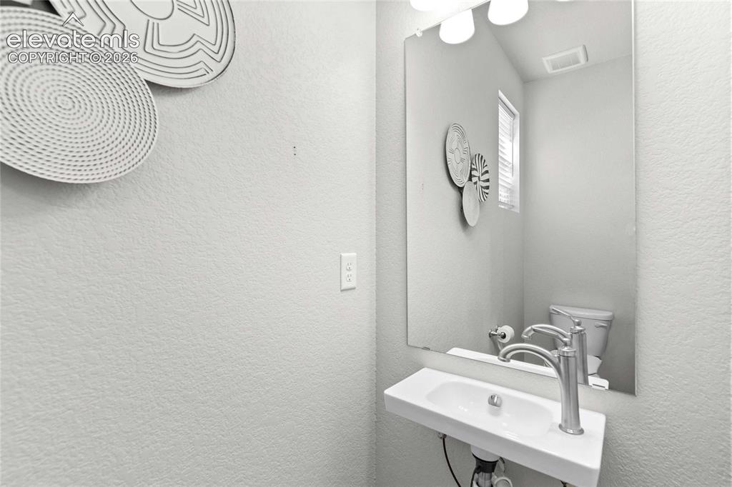 Image 12 of 25: Wall-mounted rectangular sink with a single-handle chrome faucet
*photos o