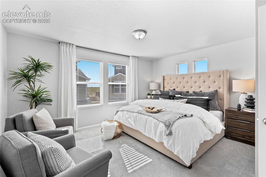 Image 16 of 25: Neutral gray wall paint, recessed lighting, double windows with blinds, lig