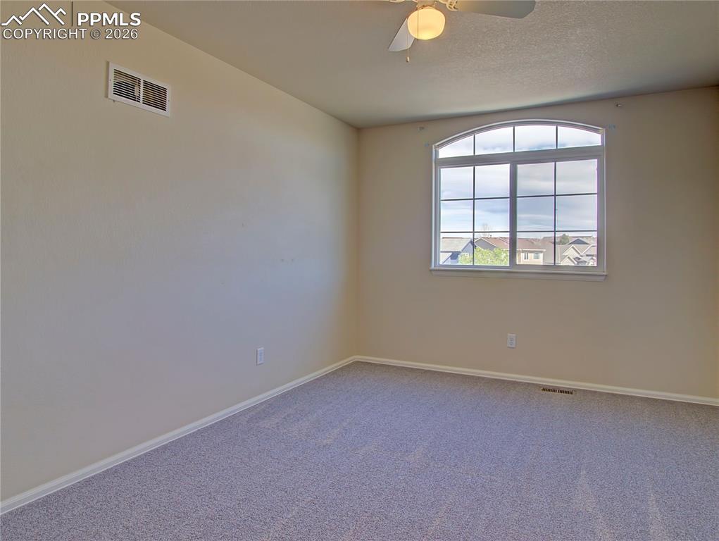 Image 17 of 27: Upper level front  bedroom