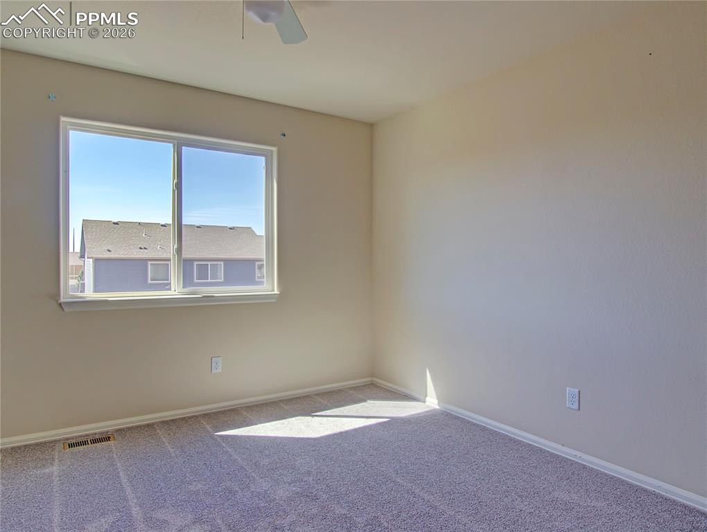Image 19 of 27: upper level back bedroom