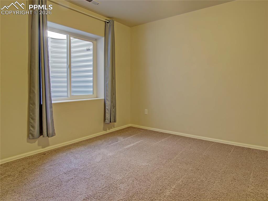 Image 25 of 27: basement back bedroom
