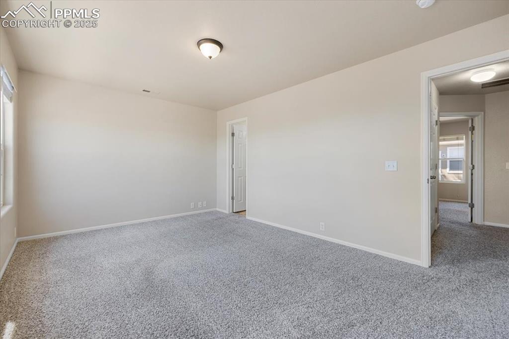 Image 22 of 42: Empty room featuring carpet flooring and baseboards