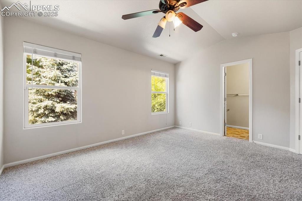 Image 28 of 42: Unfurnished bedroom featuring carpet flooring, lofted ceiling, a ceiling fa