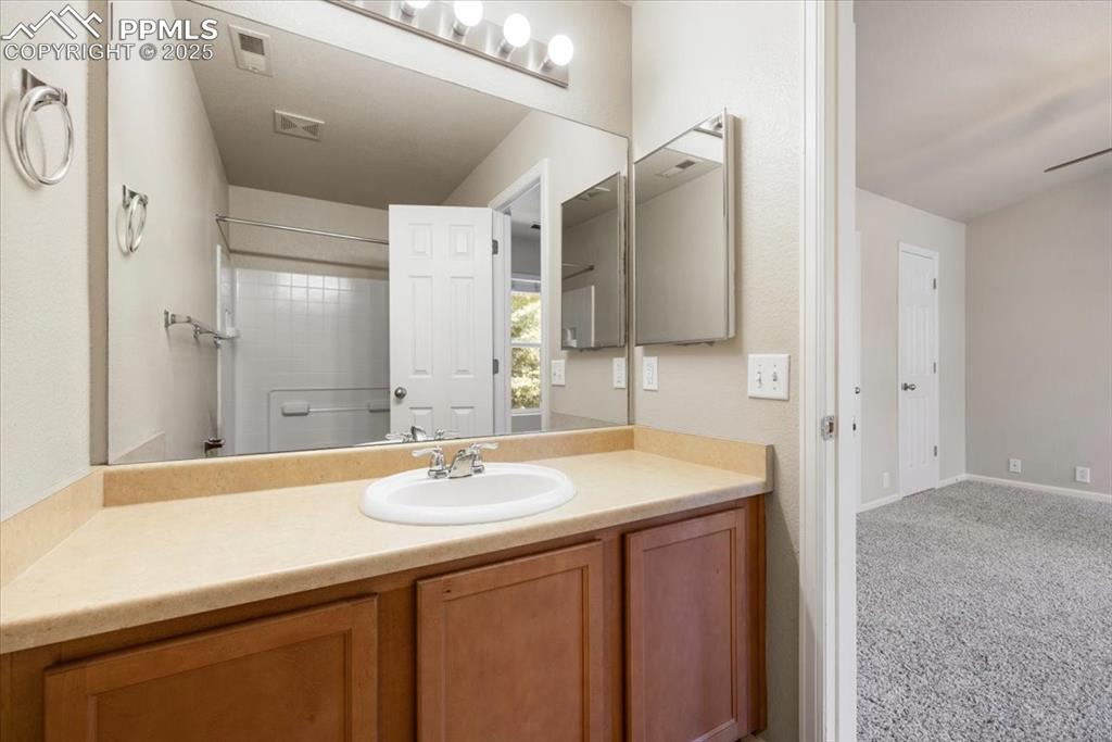 Image 32 of 42: Bathroom with vanity and baseboards