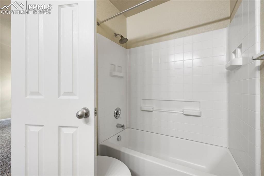 Image 33 of 42: Bathroom with shower / bathtub combination and toilet