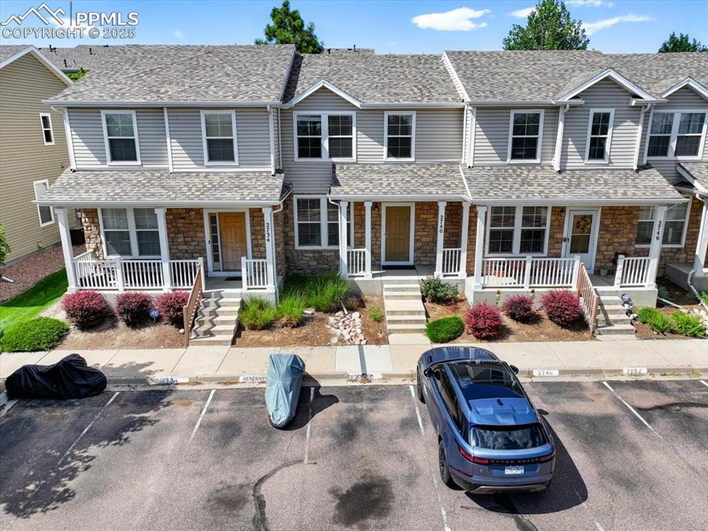 Image 37 of 42: Traditional-style home featuring a porch, uncovered parking, and stone sidi