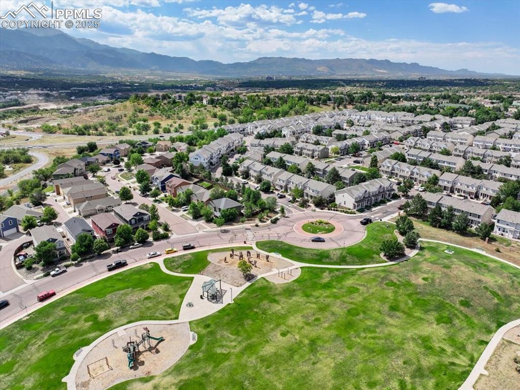 Image 40 of 42: Aerial perspective of suburban area featuring a mountainous background