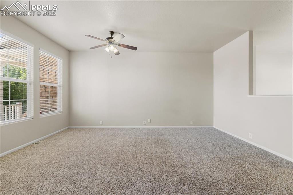 Image 7 of 42: Carpeted empty room featuring baseboards and a ceiling fan