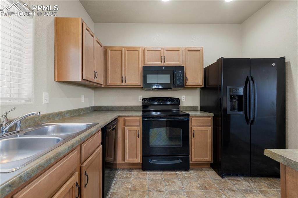 Image 9 of 42: Kitchen featuring black appliances and dark countertops
