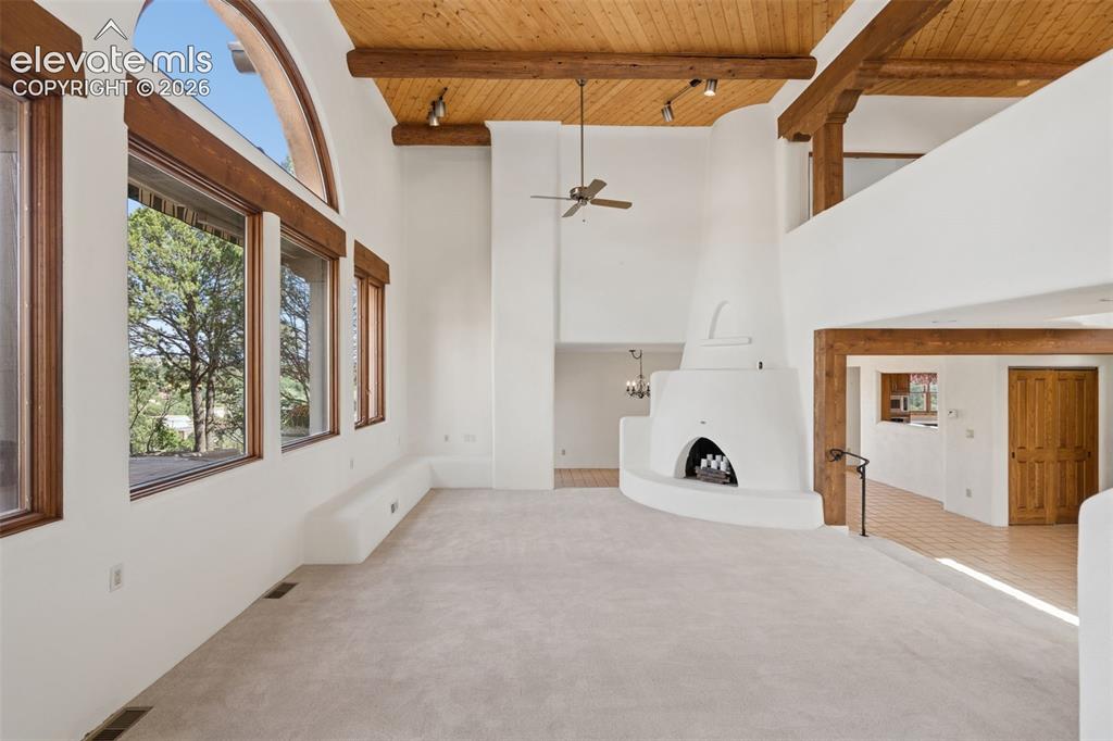Image 13 of 46: Designed around its setting, the living room combines architectural warmth 