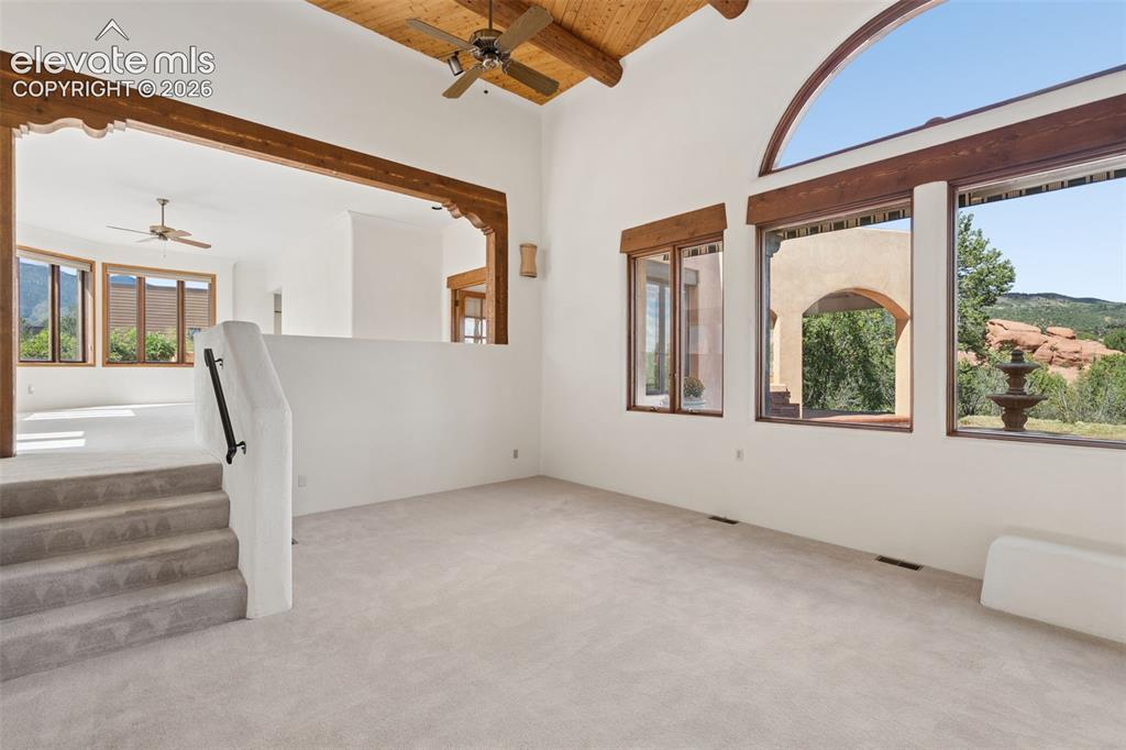 Image 15 of 46: From the living room, the upper family room overlooks the space below, show