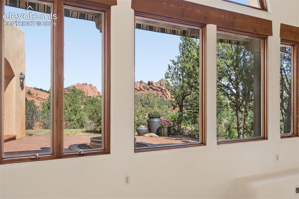 Image 18 of 46: Garden of the Gods reflects across the windows, a striking reminder of how 