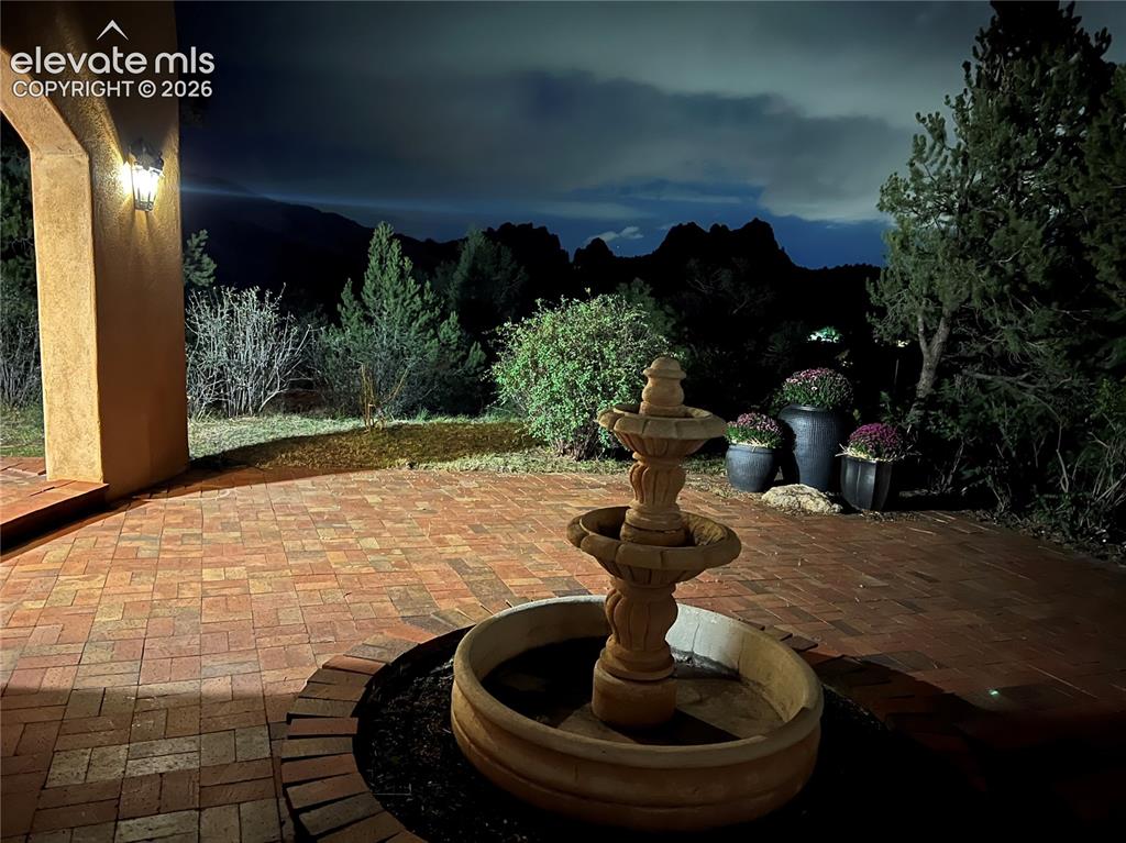Image 19 of 46: As evening settles in, the softly lit patio creates an inviting outdoor spa