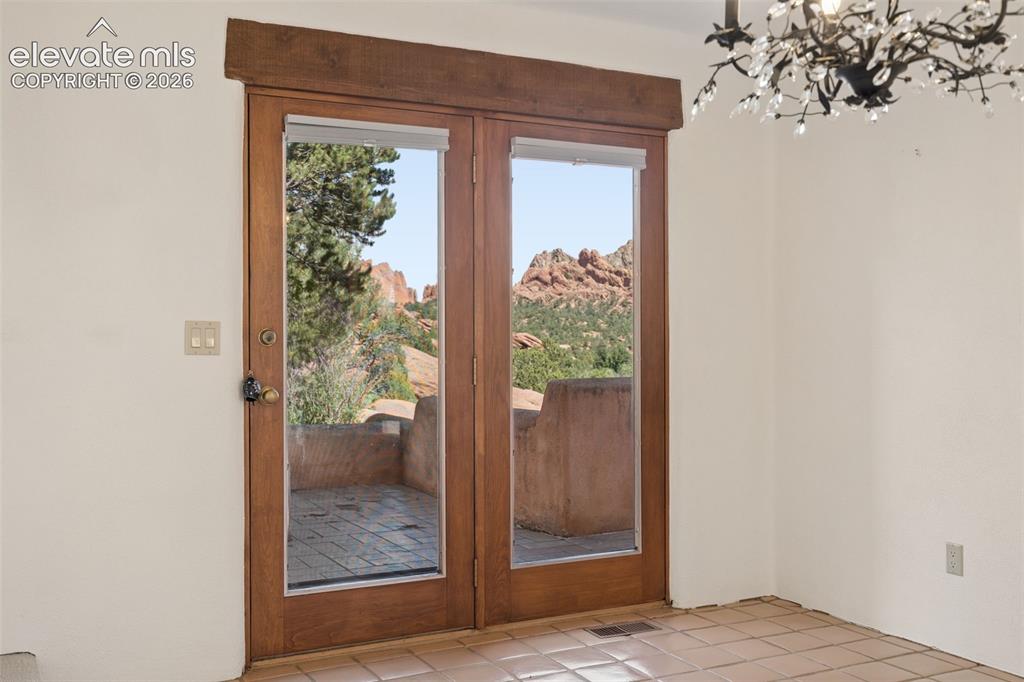 Image 22 of 46: French doors extend dining outdoors, creating an easy flow between entertai